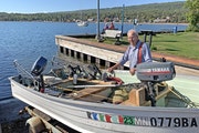 Pete Harris of Grand Marais with the vintage 14-foot boat he uses to fish lake trout on Lake Superior.