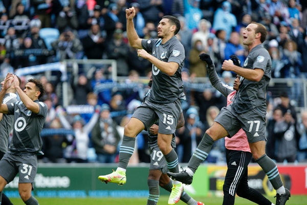 Minnesota United players Hassani Dotson (31), Michael Boxall (15) and Chase Gasper (77) saluted the Allianz Field crowd after defeating Sporting Kansa