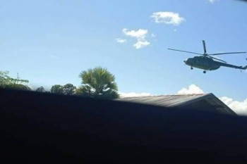 A military helicopter hovers above Pinlebu on Saturday evening (Supplied)