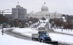 In 2019, a snowplow made its way up the hill in front of the Cathedral of St. Paul, with the Capitol in the background.  