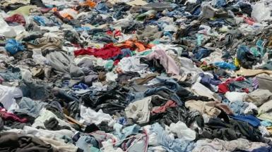Abandoned clothes in landfill