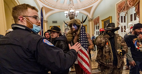 Supporters of President Donald Trump are confronted by Capitol Police officers outside the Senate Chamber at the Capitol, Wednesday, Jan. 6, 2021