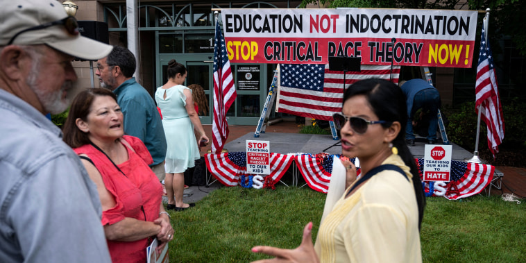 Image: Protesters talk before the start of a rally against critical race theory being taught in schools at the Loudoun County Government Center in Leesburg, Va., on June 12, 2021.