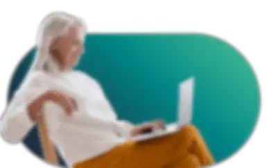A woman sitting in a chair with a laptop