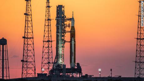 The sunrise casts a warm glow around the Artemis I Space Launch System (SLS) and Orion spacecraft at Launch Pad 39B at NASA&#39;s Kennedy Space Center in Florida on March 21, 2022. The SLS and Orion atop the mobile launcher were transported to the pad on crawler-transporter 2 for a prelaunch test called a wet dress rehearsal. Artemis I will be the first integrated test of the SLS and Orion spacecraft. In later missions, NASA will land the first woman and the first person of color on the surface of the Moon, paving the way for a long-term lunar presence and serving as a steppingstone on the way to Mars