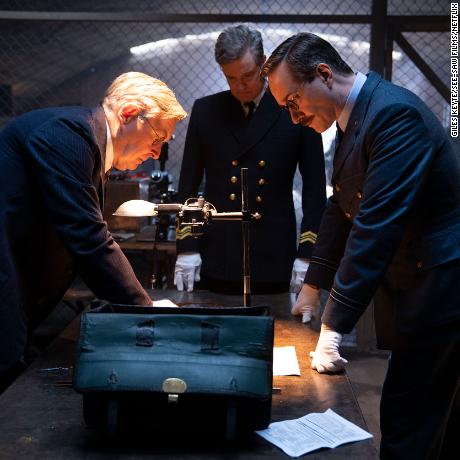OPERATION MINCEMEAT (2022) James Fleet as Charles Fraser-Smith, Colin Firth as Ewen Montagu and Matthew Macfadyen as Charles Cholmondeley.  Cr: Giles Keyte/Courtesy See-Saw Films and Netflix