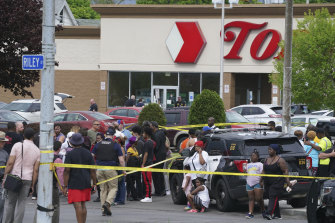 People gather outside a Buffalo, New York, supermarket where several people were killed in a shooting.