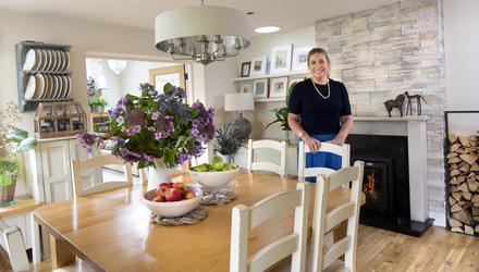 Peigín Crowley in the dining area of her kitchen/living/dining room. The floating shelves behind are full of artworks by her mother, Karin, who is half-German, half-Welsh. Picture by Tony Gavin.