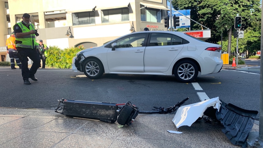 A crumpled scooter and a car with damage. 