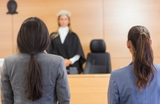 anonymous women face a female judge in a courtroom