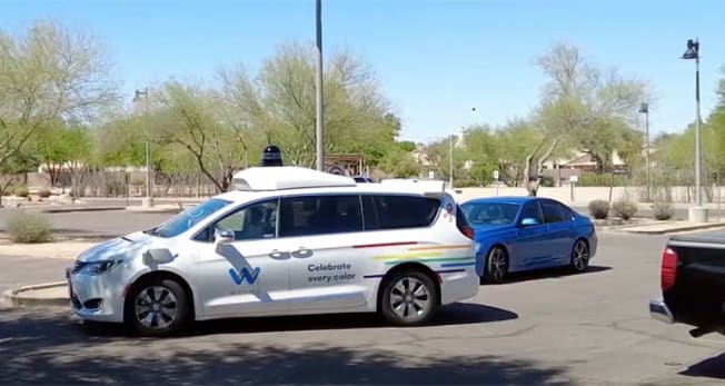 Waymo driverless van negotiating a parking lot