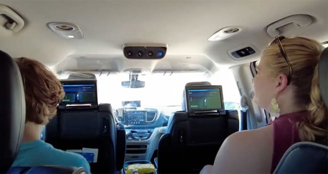 Riders in a Waymo driverless van