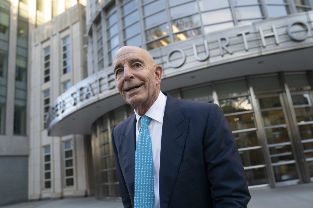 A bald man in business suit outside a courthouse