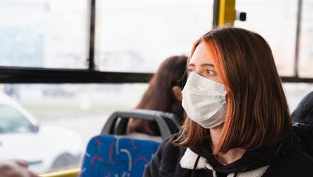 A woman wears a mask while commuting to help reduce the spread of the virus. Photo: Stock image