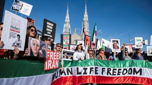 Protesters in support of women in Iran hold a banner reading 'Women Life Freedom' during a protest following the death of Mahsa Amini, in Ottawa, Canada. Photo: Spencer Colby/Reuters
