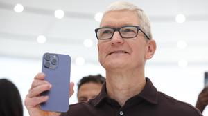 SEPTEMBER 07: Apple CEO Tim Cook looks at a new iPhone 14 Pro during an Apple special event on September 07, 2022 in Cupertino, California. Apple unveiled the new iPhone 14 as well as new versions of the Apple Watch, including the Apple Watch SE, a low-cost version of the popular timepiece that will start at $249. (Photo by Justin Sullivan/Getty Images)