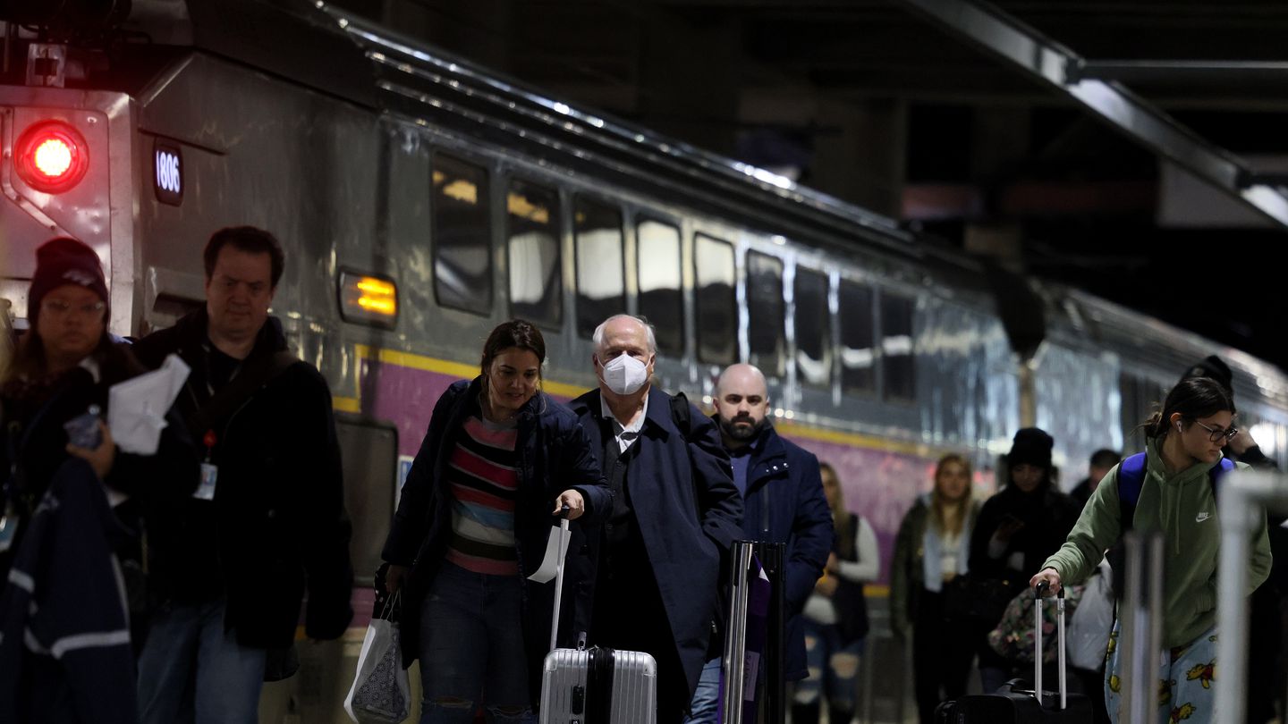 A mix of riders, some wearing masks and others not, disembarked from a commuter rail train at South Station on Thursday.
