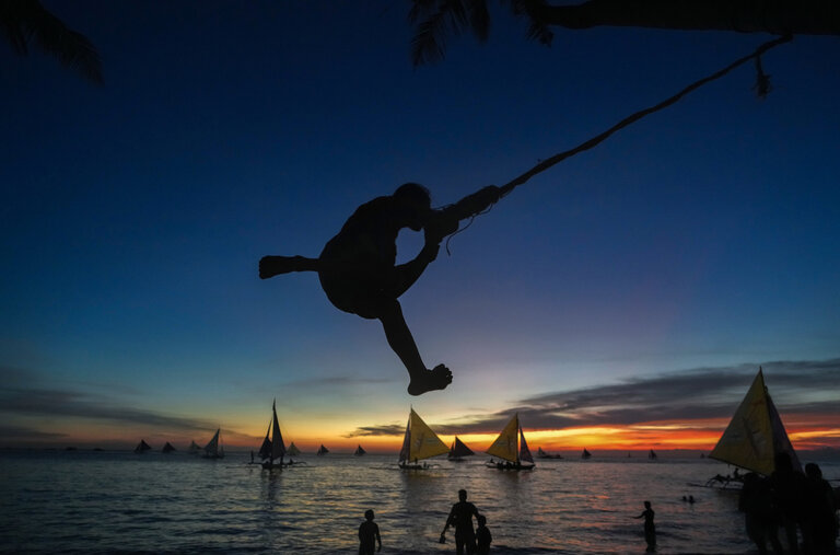 Sunset on Boracay’s White Beach feels lively, but some worry it will tip back into being overcrowded.