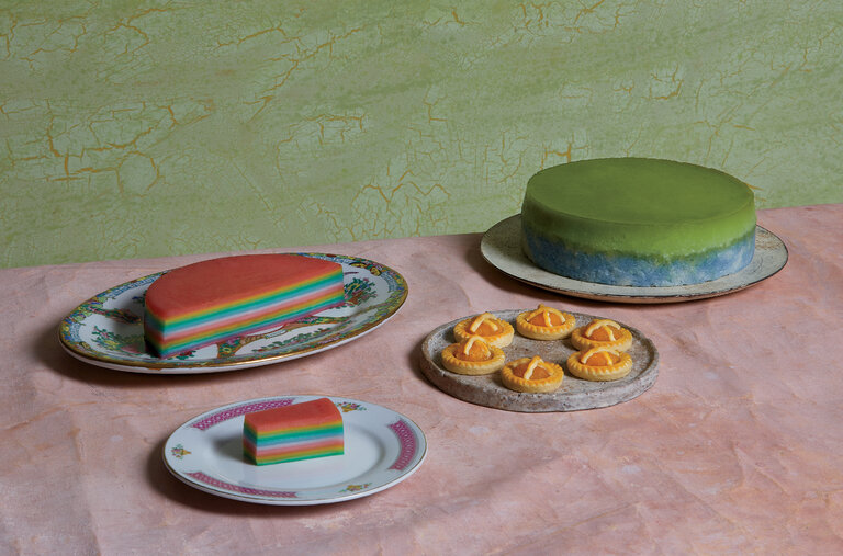 On this and the following pages, Peranakan favorites made by the Singapore-born, New York- based cookbook author Sharon Wee, who ate around Singapore with this article’s writer. From left: kueh lapis kukus (steamed rainbow layer cake), pineapple tarts and puteri salat (steamed coconut milk custard on glutinous rice).