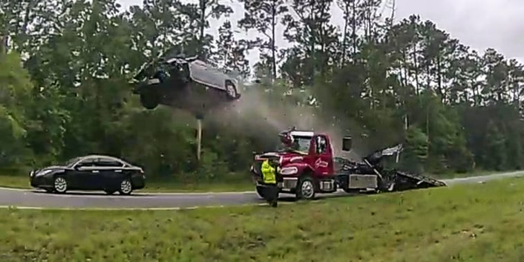 A car launches off a tow truck ramp in Lowndes County, Ga.