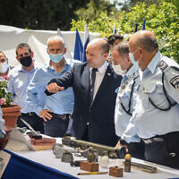 Prime Minister Naftali Bennett, Public Security Minister Omer Barlev and Chief of Police Kobi Shabtai during a ceremony marking the opening of a new police station in the northern Israel city of Kiryat Ata, August 11, 2021. (Roni Ofer/Flash90)