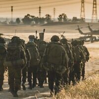 Israeli troops are seen near combat helicopters during a major military drill dubbed 'Firm Hand,' in a handout image published by the IDF on June 8, 2023. (Israel Defense Forces)