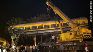 Rescuers search for survivors after a collision between two passenger trains south of Cairo.