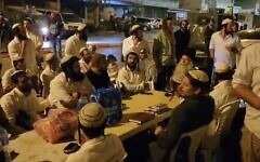 Far-right Religious Zionism MK Zvi Sukkot and other Israeli Jews pray in Huwara, after he set up a sukkah in the Palestinian town to protest a shooting attack there, October 5, 2023. (X. Used in accordance with Clause 27a of the Copyright Law)