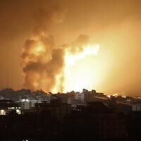 Fire and smoke rises above buildings during an Israeli air strike in Gaza City on October 8, 2023. (EYAD BABA / AFP)