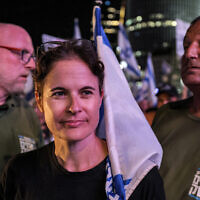 Shikma Bressler, a leader of the protest movement against the government's judicial overhaul, arrives with bodyguards at the weekly protest in Tel Aviv on September 30, 2023. (Ahmad Gharabli/AFP)