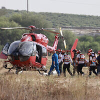 Israeli rescue teams evacuate a wounded person by helicopter near the southern city of Sderot on October 7, 2023 (Menahem KAHANA / AFP)