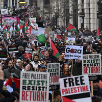 People walk down Regent Street as they take part in a 'March For Palestine' in London on October 14, 2023. (Justin Tallis/AFP)