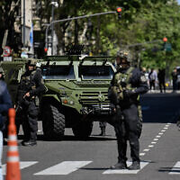 Police officers stand guard on Mayo Avenue in Buenos Aires after the Israeli embassy received a bomb threat, Oct. 18, 2023 (Luis ROBAYO / AFP)
