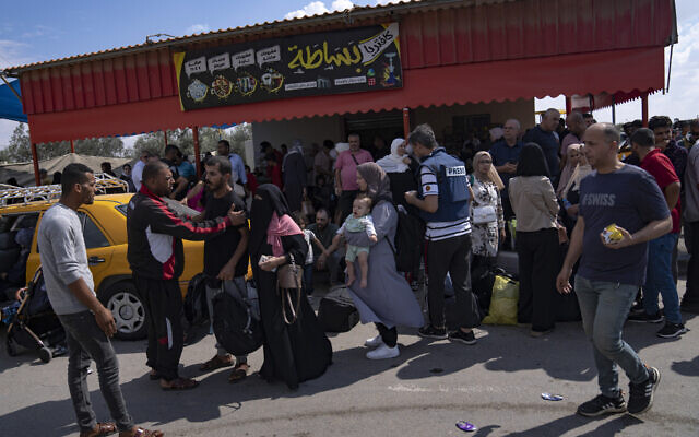 Palestinians wait to cross into Egypt at the Rafah border crossing in the Gaza Strip, October 16, 2023. (Fatima Shbair/AP)