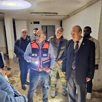 State Comptroller Matanyahu Englman, right, and Ma’alot-Tarshiha Mayor Arkady Pomeranets touring a bomb shelter in the city, October 17, 2023. (Courtesy State Comptroller’s Office)