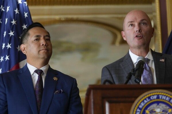 Utah Attorney General Sean Reyes listens as Gov. Spencer Cox speaks during a press conference following the announcement that Utah filed a lawsuit against TikTok at the Utah State Capitol in Salt Lake City, Utah on Tuesday, Oct. 10, 2023. (Bethany Baker/The Salt Lake Tribune via AP)