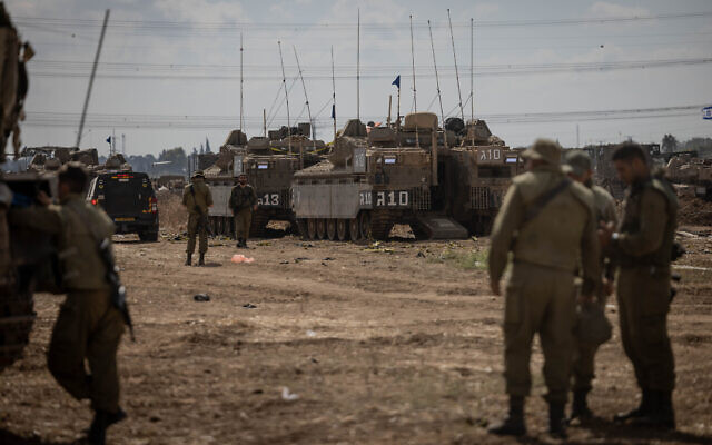 Israeli soldiers at a staging area near the Gaza border, October 19, 2023. (Chaim Goldberg/Flash90)