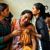 Manju Devi Danguara (2nd left), the mother of Ashish Chaudhary, is consoled by family members at her residence in the Kailali district of Sudurpashchim province as she mourns the loss of her son, who was killed in Hamas's devastating onslaught in Israel, October 13, 2023. (Prakash MATHEMA/AFP)
