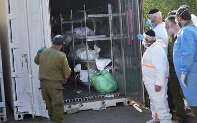 The bodies of Israelis killed in a Hamas-led slaughter are gathered for identification at a military base in Ramle, Oct. 13, 2023. (AP Photo/Ohad Zweigenberg)