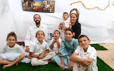 Amichai Shindler (back row, left), his wife during the Sukkot holiday, October 2023. Days later, Hamas terrorists attacked the family in their home and Amichai was badly injured. (Courtesy of Shindler family)