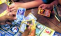 Children swap Pokémon cards. The trading card game has been running since 1996