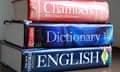 English dictionaries stacked on a desk.