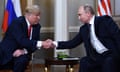 A seated Donald Trump shaking hands with Vladimir Putin in front of Russian and American flags