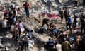 Palestinians work in the debris of buildings that were targeted by Israeli airstrikes in Jabalia refugee camp