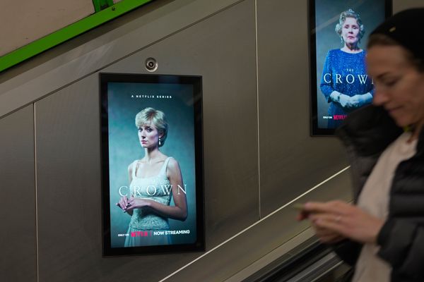 The screen shows an advertisement of the popular Netflix series "The Crown," in an underground station, in London, Friday, Nov. 18, 2022.