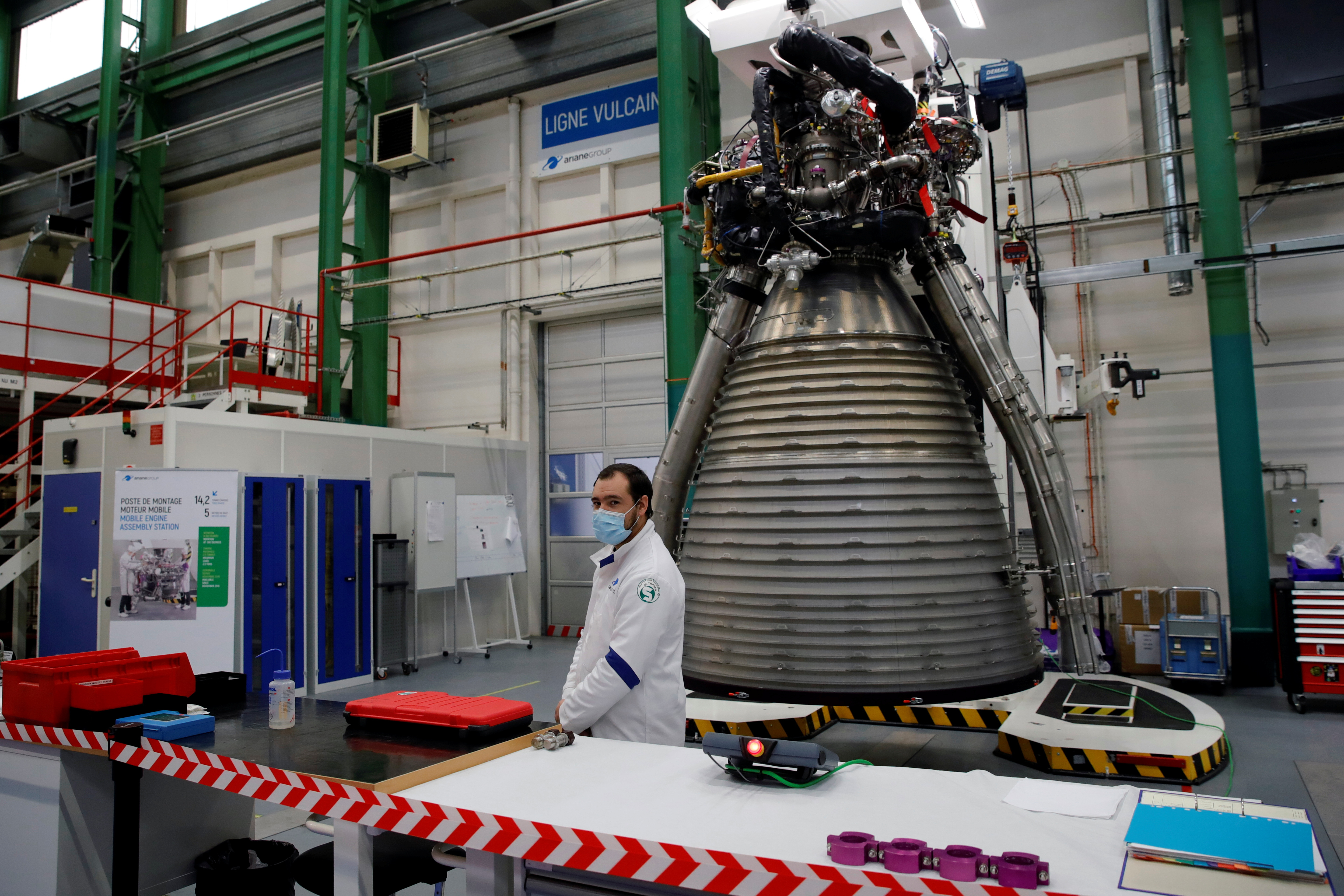 A worker of Ariane Group stands in front of a Ariane 6 rocket's Vulcain 2.1 engine, prior to the visit of French President Emmanuel Macron, in Vernon