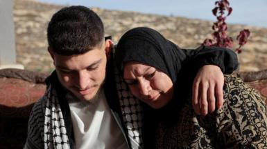 Released Palestinian prisoner Qusai Taqatqa hugs his mother near his house