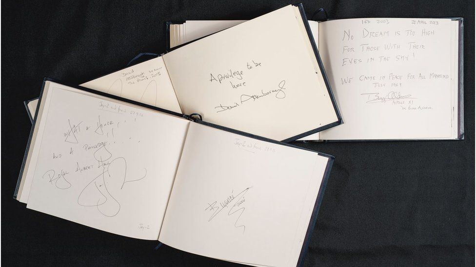 Three Royal Albert Hall guestbooks on a black cloth