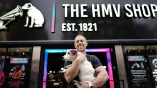 HMV owner Doug Putman with Holly the dog outside the Oxford Street store