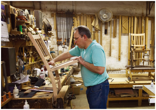In Amana, Iowa, a worker makes furniture at the Amana Furniture & Clock Shop. The shop was opened when German immigrants established the communal Amana Colonies in 1855.